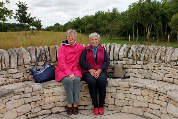 Trish and Catherine sit on the WI seat.jpg